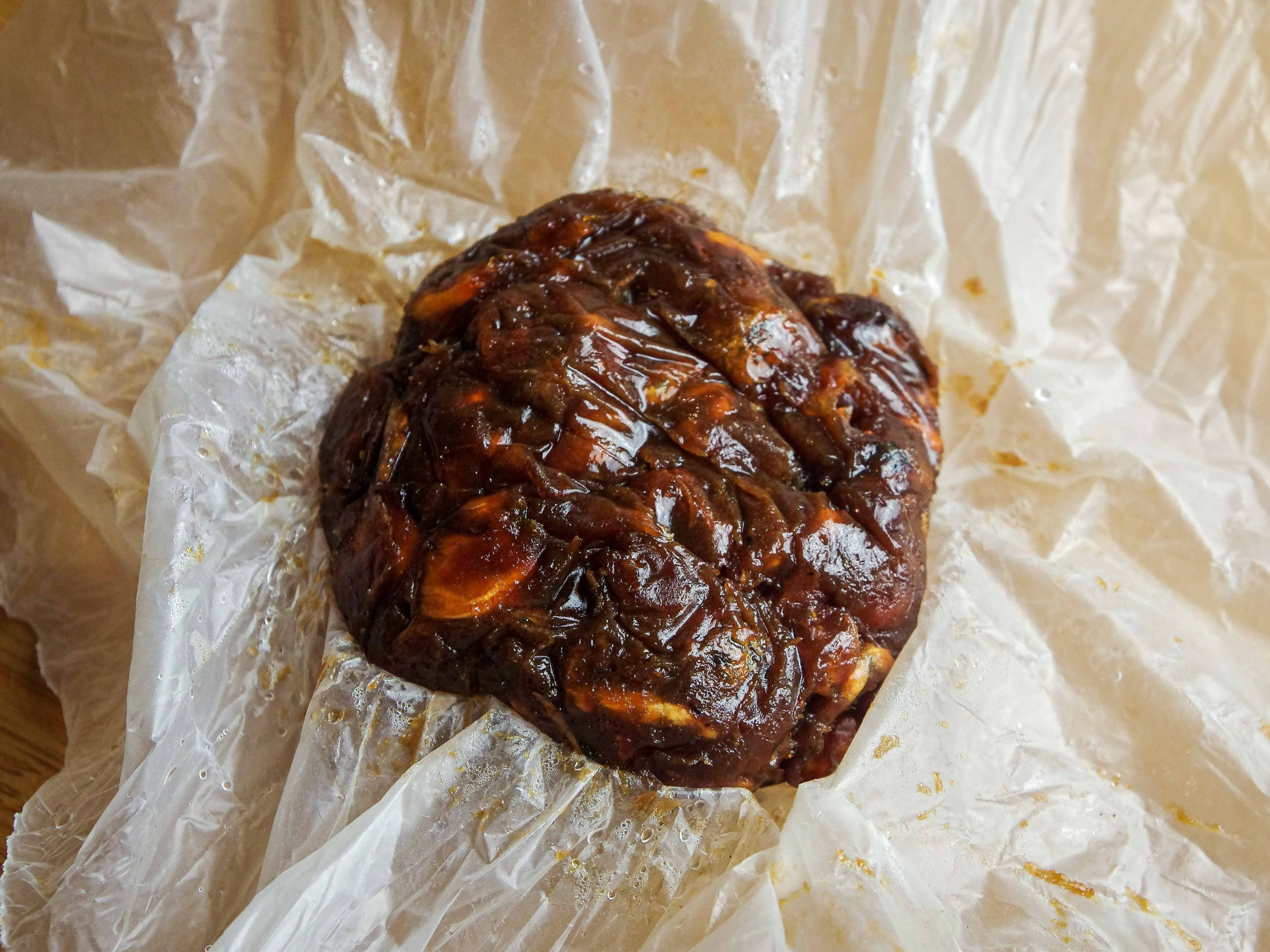 A block of asam jawa in plastic wrapping.