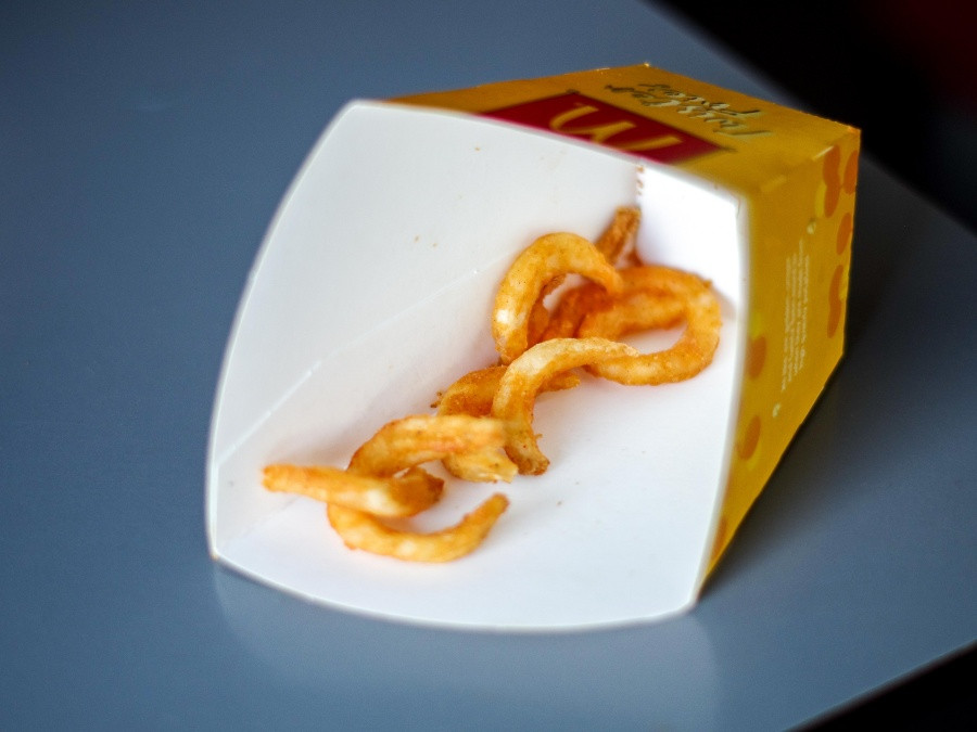 Curly fries in a paper cup. Photo: Michelle Yip